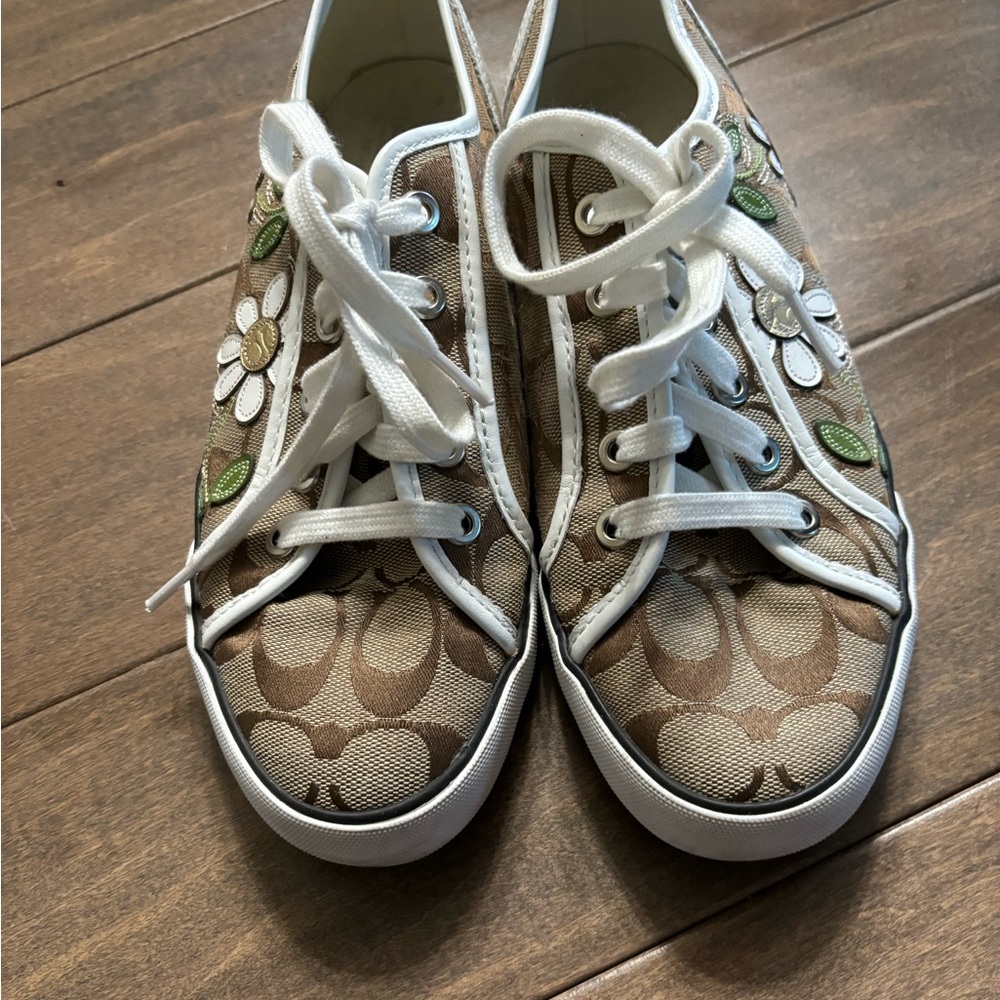 Low top coach, tennis shoes with daisies on the side. Barely worn size 8.